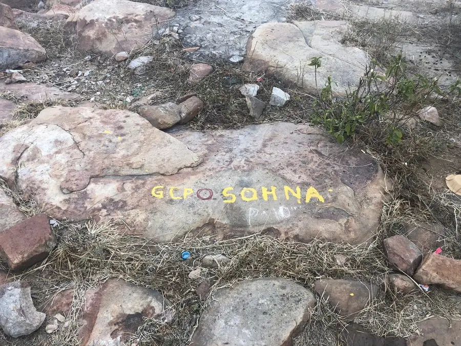 Painted ground control point marker on rock