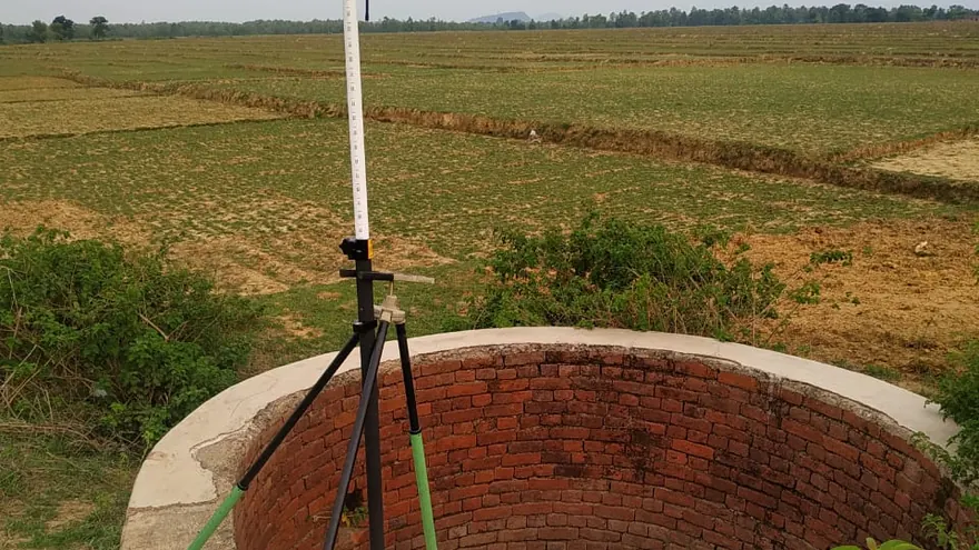 GNSS observation set over a masonry well in open land — BTPL fieldwork on a large-area topographic survey of this type
