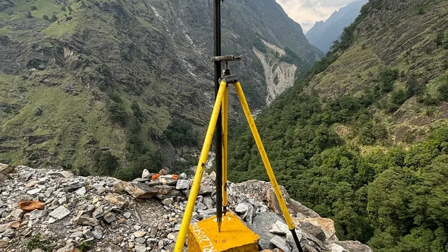 GNSS observation on rock above a river — a BTPL field image of this type of survey